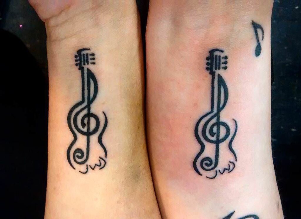 Guitar tattoo on arms for men and women