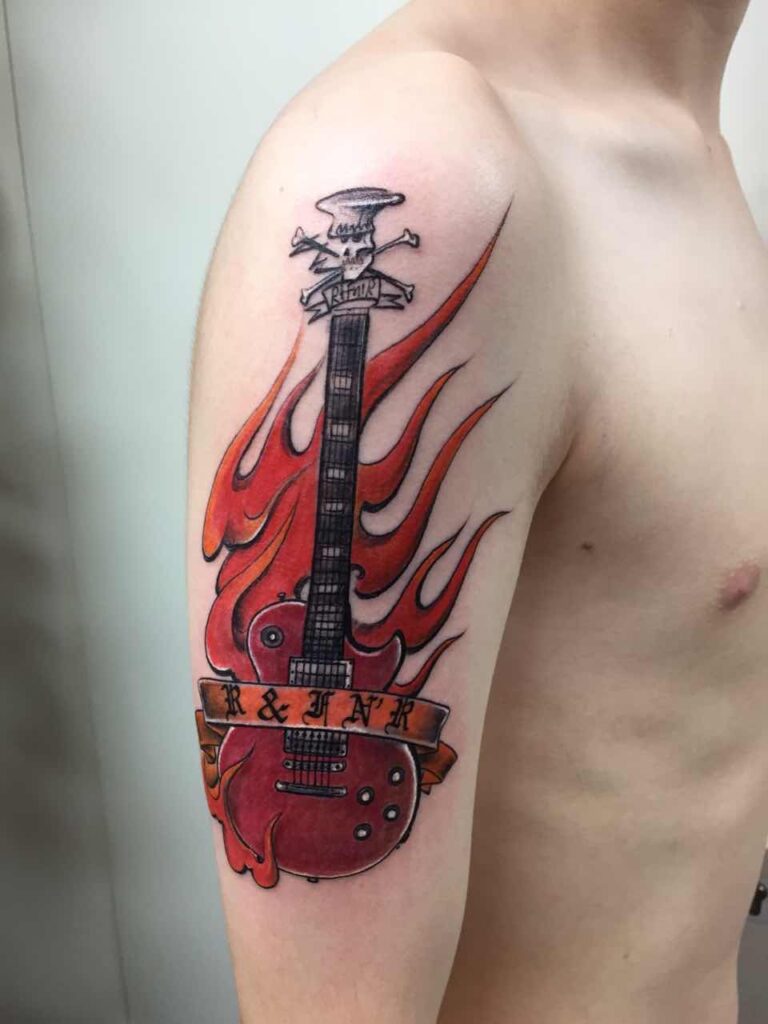 Colorful guitar tattoo on shoulder for men