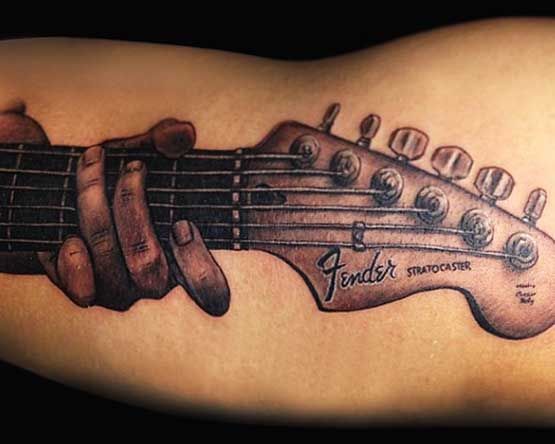 Guitar tattoo on the arm for men