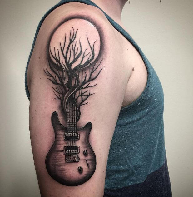 Guitar tattoo on the shoulder for men