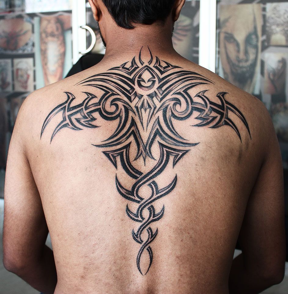 Tribal style tattoo on the back for men