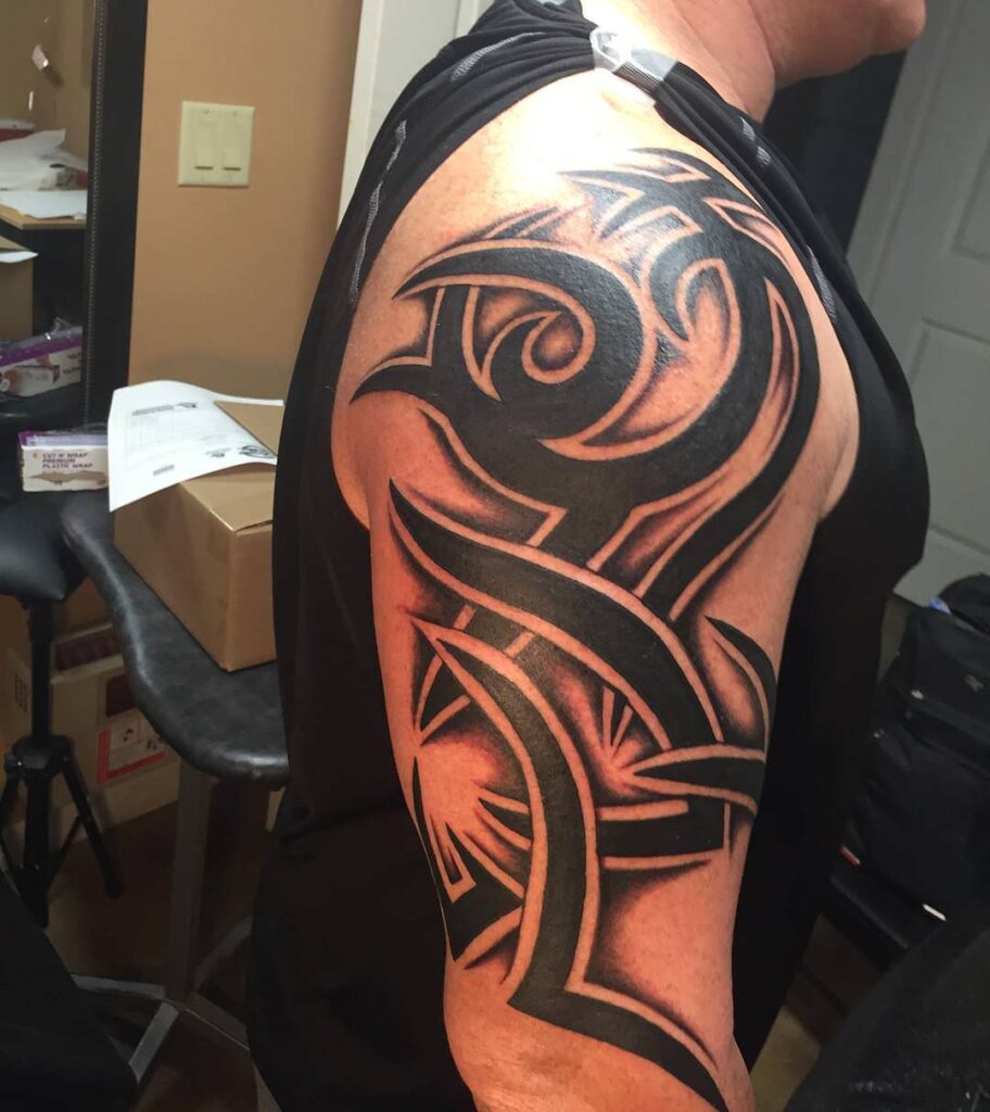 Tribal style tattoo on the shoulder for men