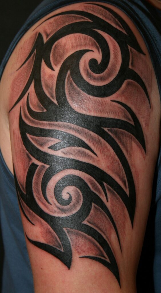 Tribal style tattoo on the shoulder for men