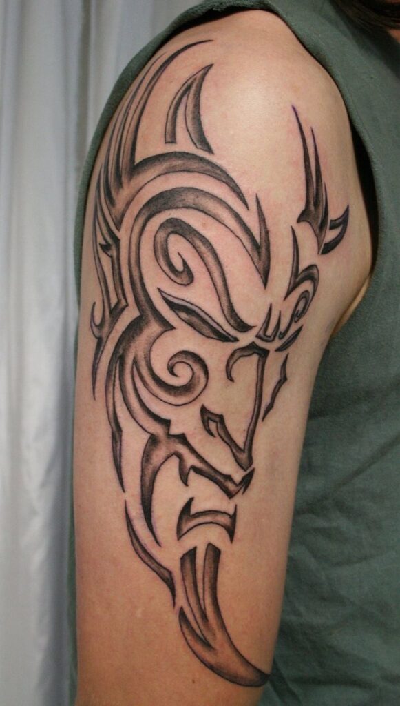 Tribal style tattoo on the shoulder for men