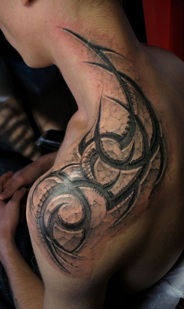 Tribal style tattoo on the shoulder for men