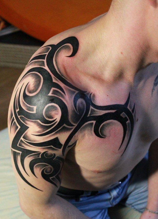 Tribal style tattoo on the shoulder for men