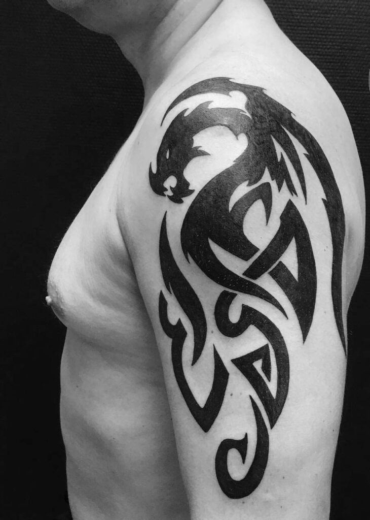 Tribal style tattoo on the shoulder for men