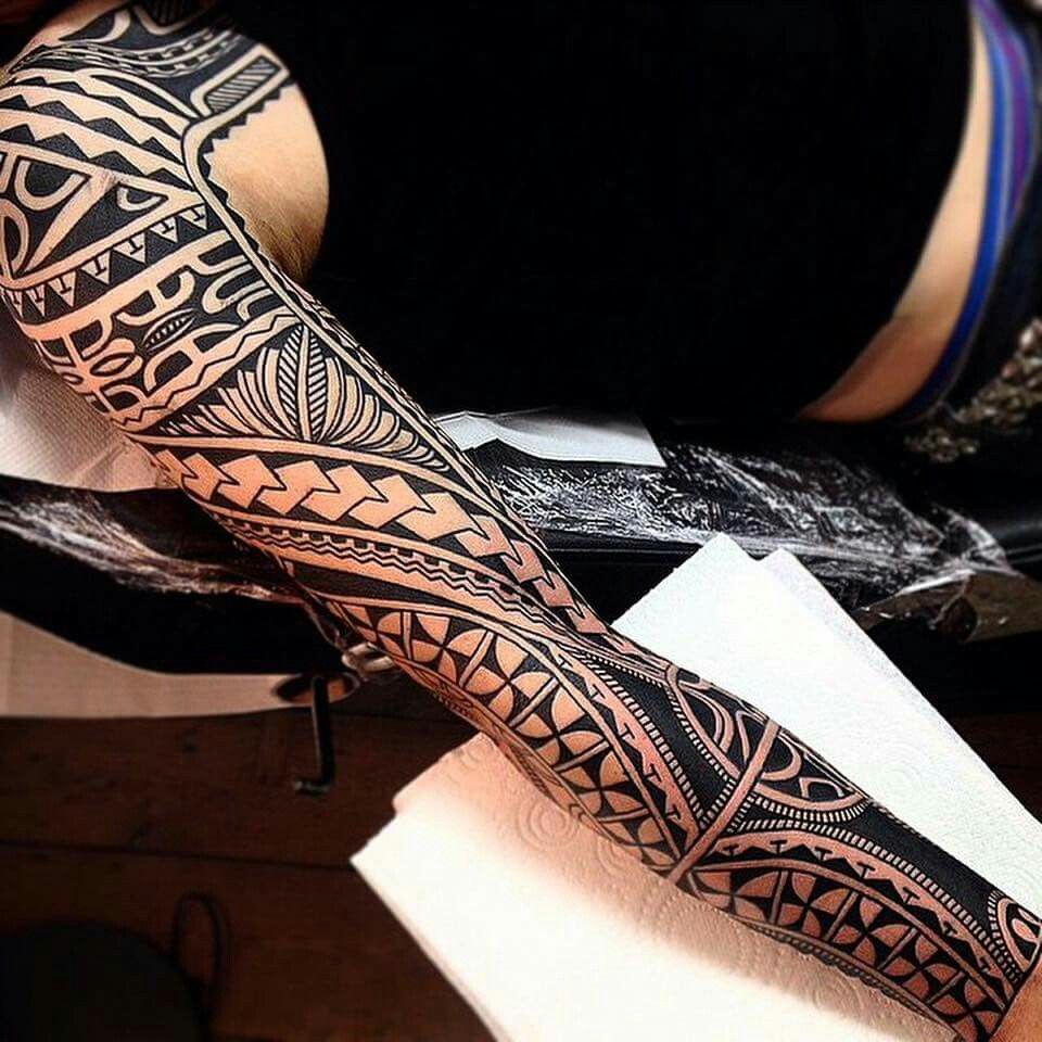 Tribal style tattoo on the arm for women