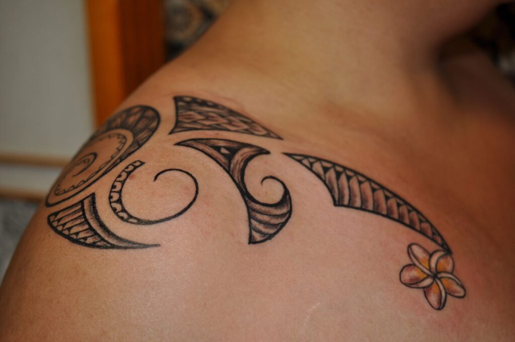 Tribal style tattoo on the collarbone for men