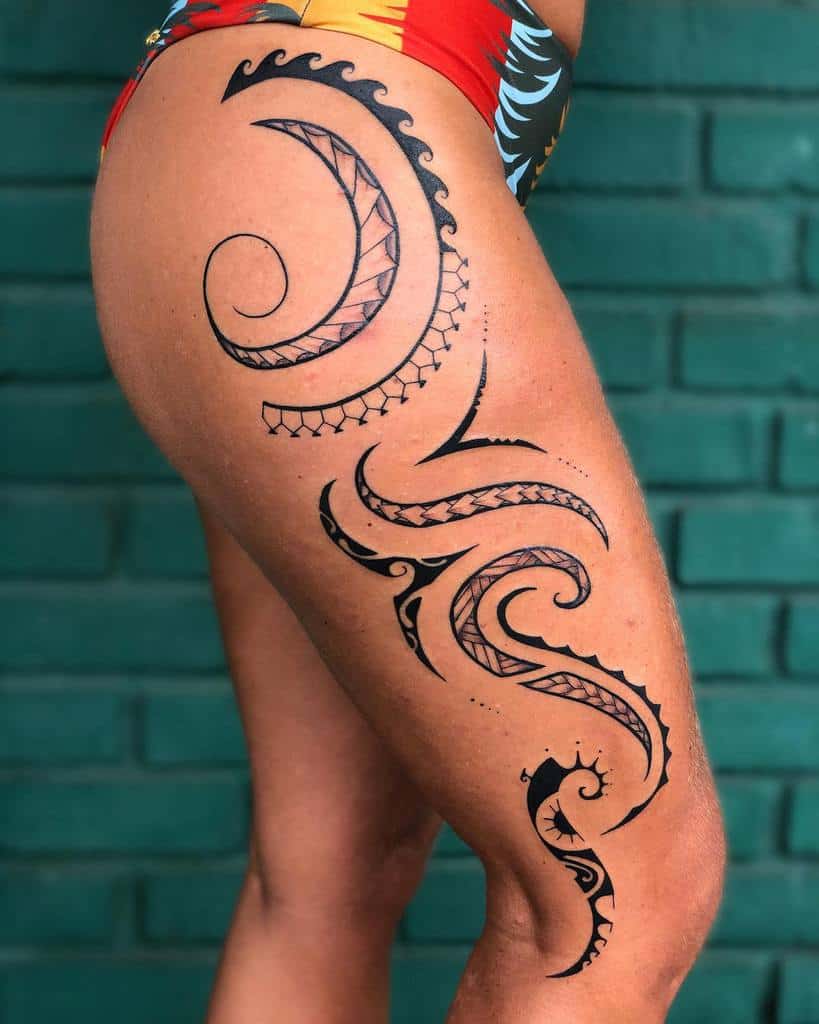 Tribal style tattoo on the thigh for women