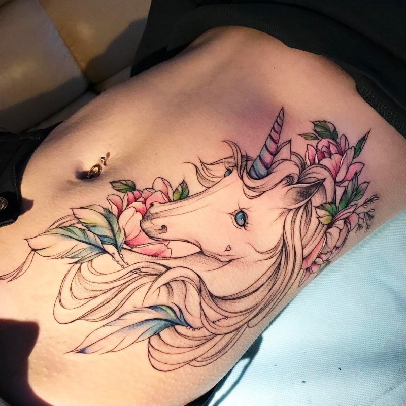 Large unicorn tattoo on the side for women