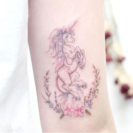 Unicorn tattoo on arm for women