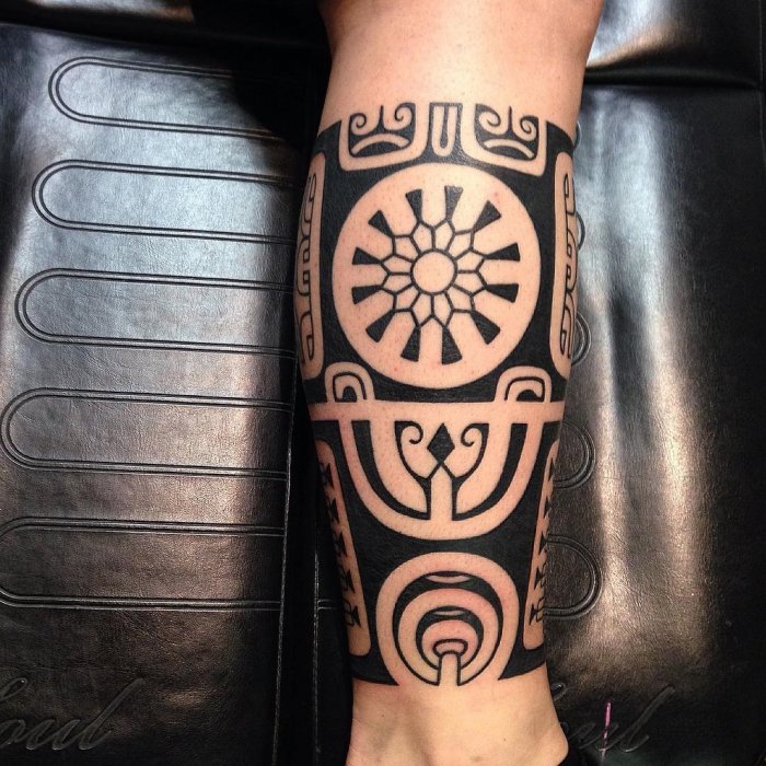 Polynesian style tattoo on the shin for men