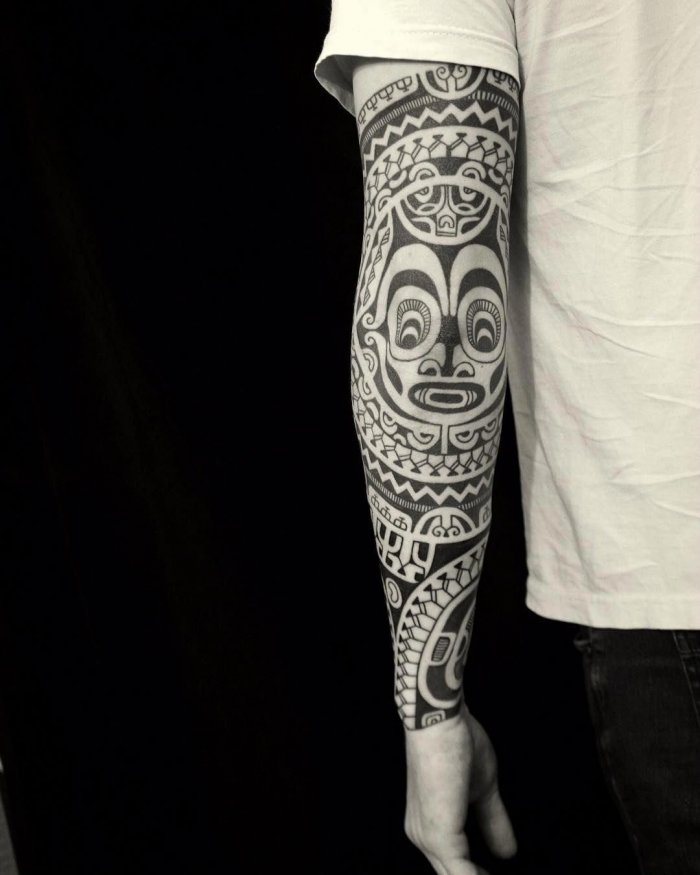 Polynesian style tattoo on the arm for men