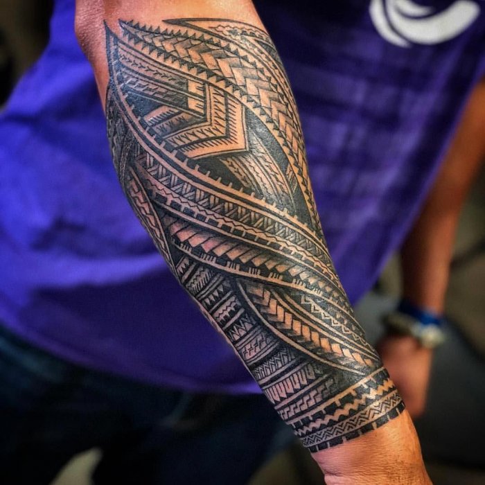 Polynesian style tattoo on the forearm for men