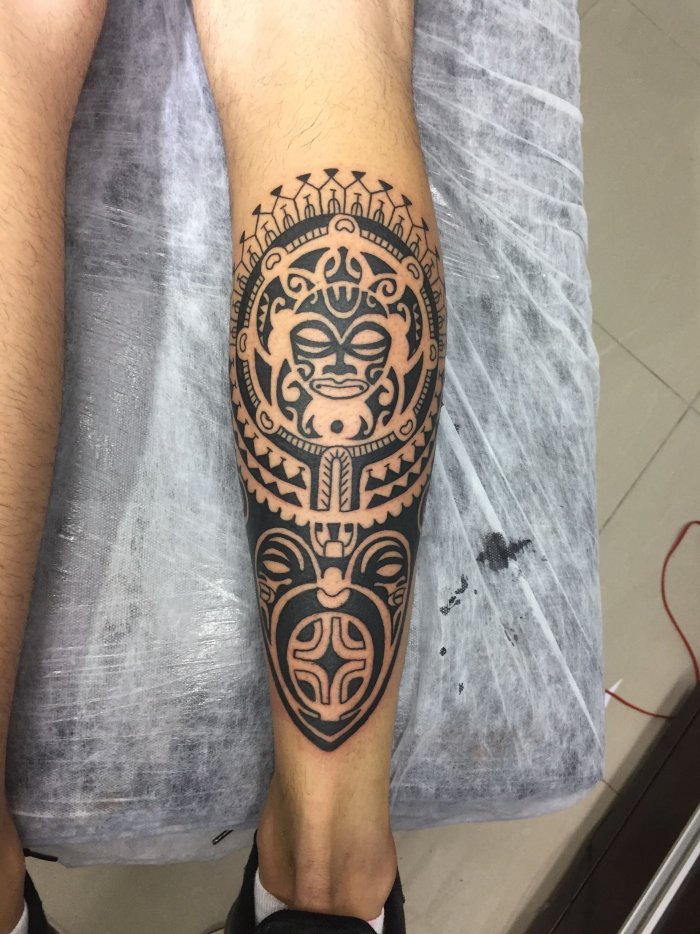 Polynesian style tattoo on the calf for men