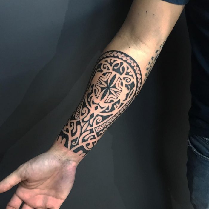 Polynesian style tattoo on the forearm for men