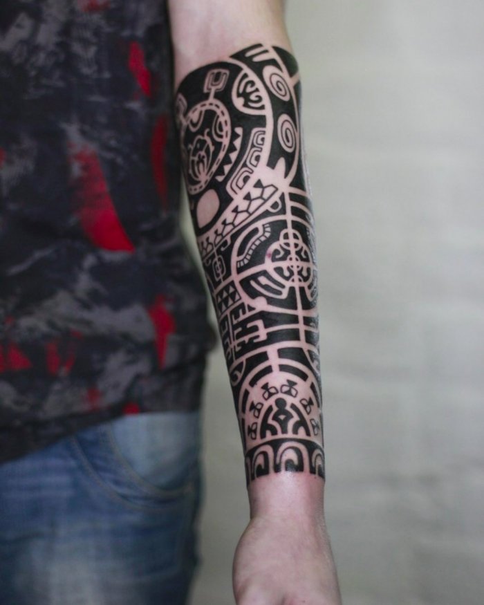 Polynesian style tattoo on the arm for men