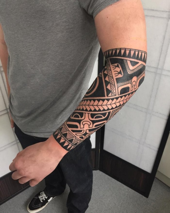 Polynesian style tattoo on the forearm for men