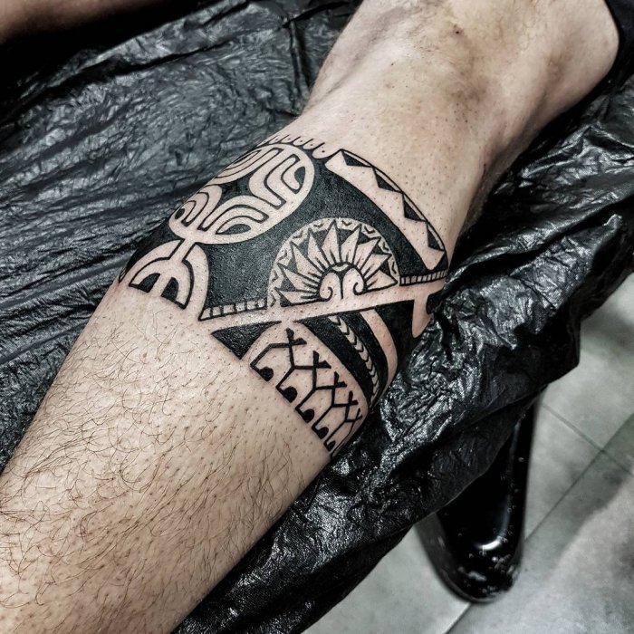 Polynesian style tattoo on the calf for men