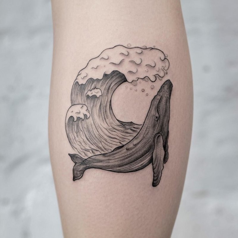 Large wave tattoo on the calf for women