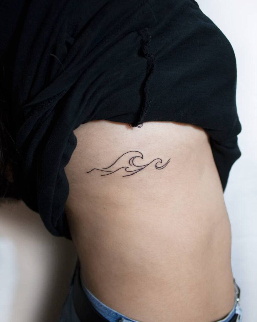 Wave tattoo on the side for women