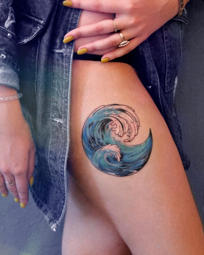 Wave tattoo on thigh for women