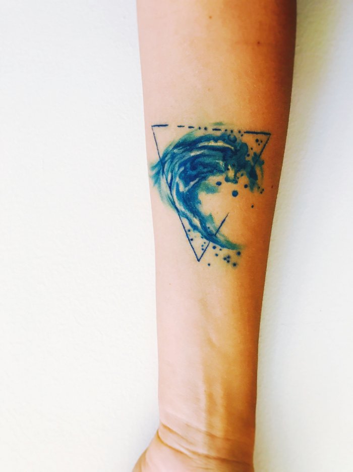 Wave tattoo on the arm for women