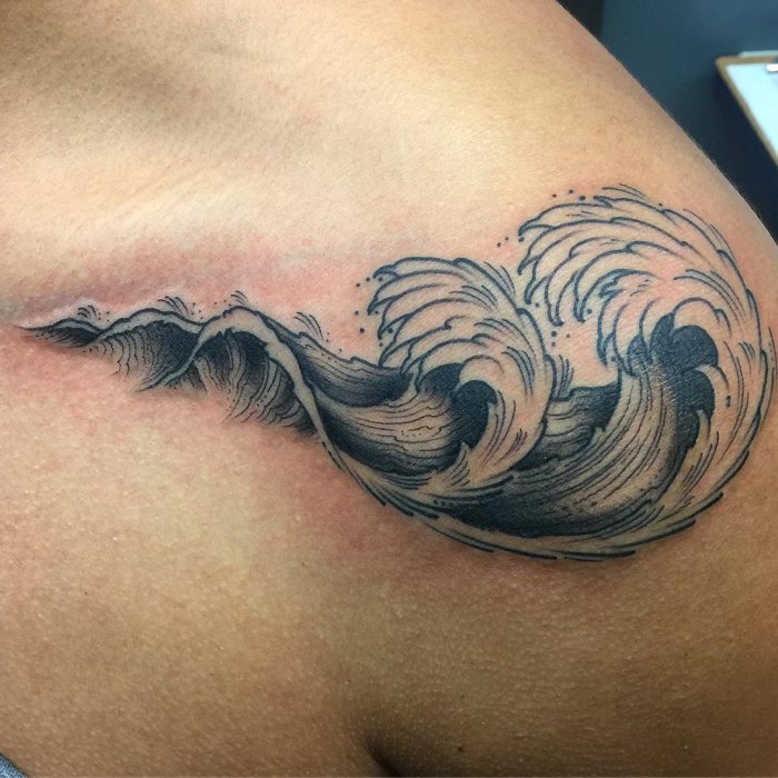 Wave tattoo on the shoulder for men