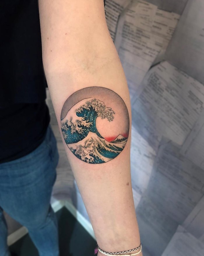 Wave tattoo on forearm for women