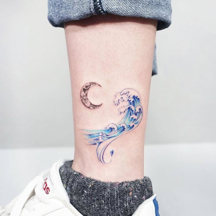 Wave tattoo on the shin for men