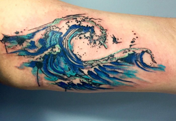 Wave tattoo on the arm for men