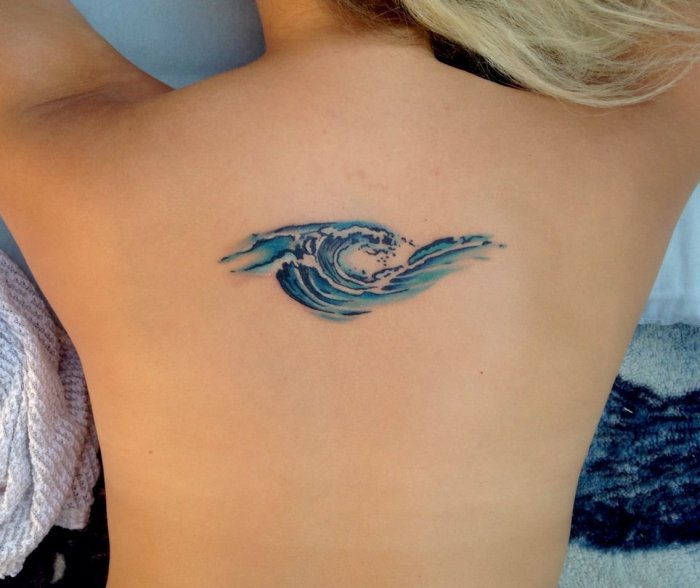 Wave tattoo on the back for women