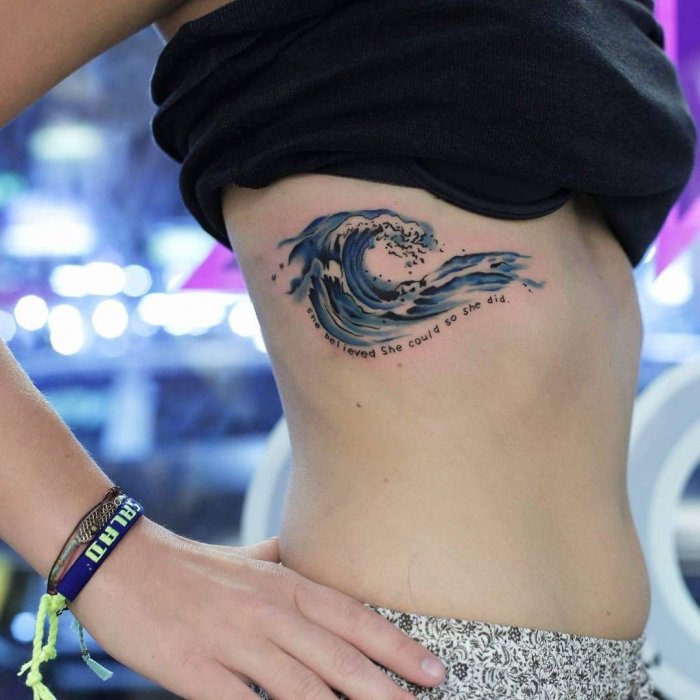 Wave tattoo on the side for women