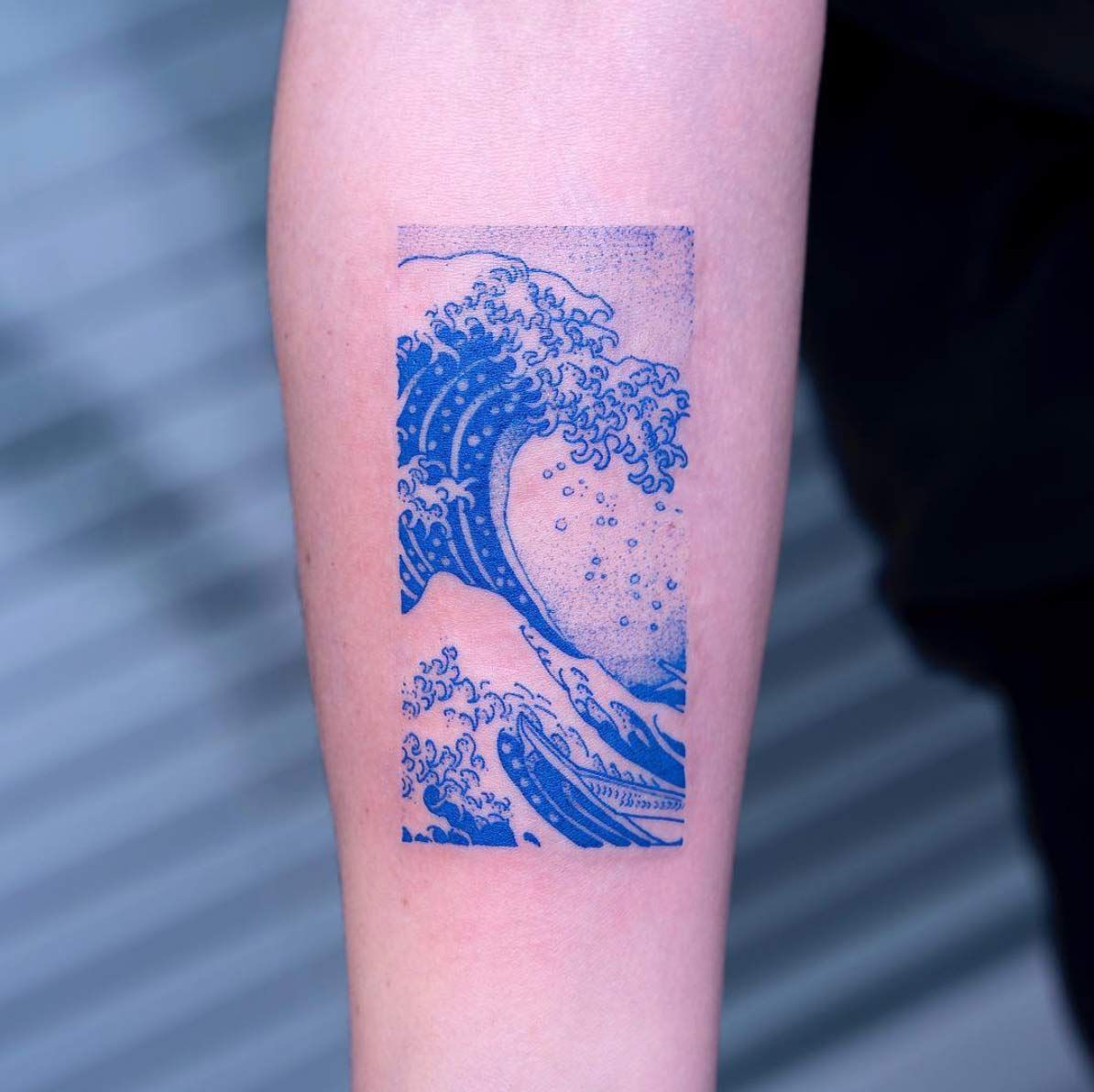 Wave tattoo on forearm for men