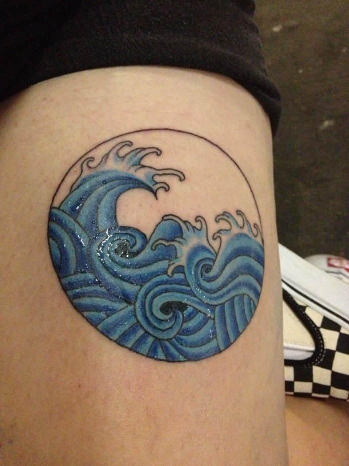 Wave tattoo on thigh for women