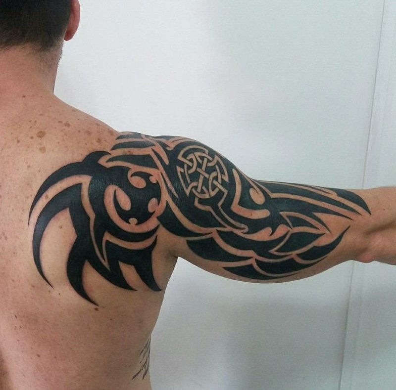 Tribal style tattoo on the arm for men