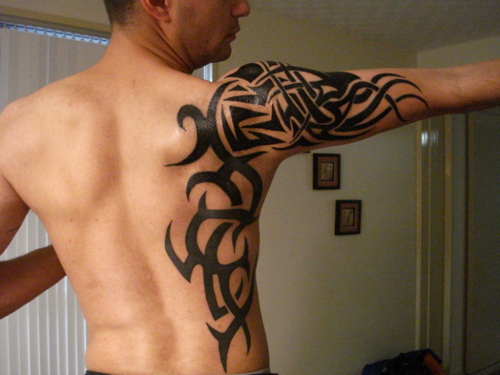 Tribal style tattoo on the side for men