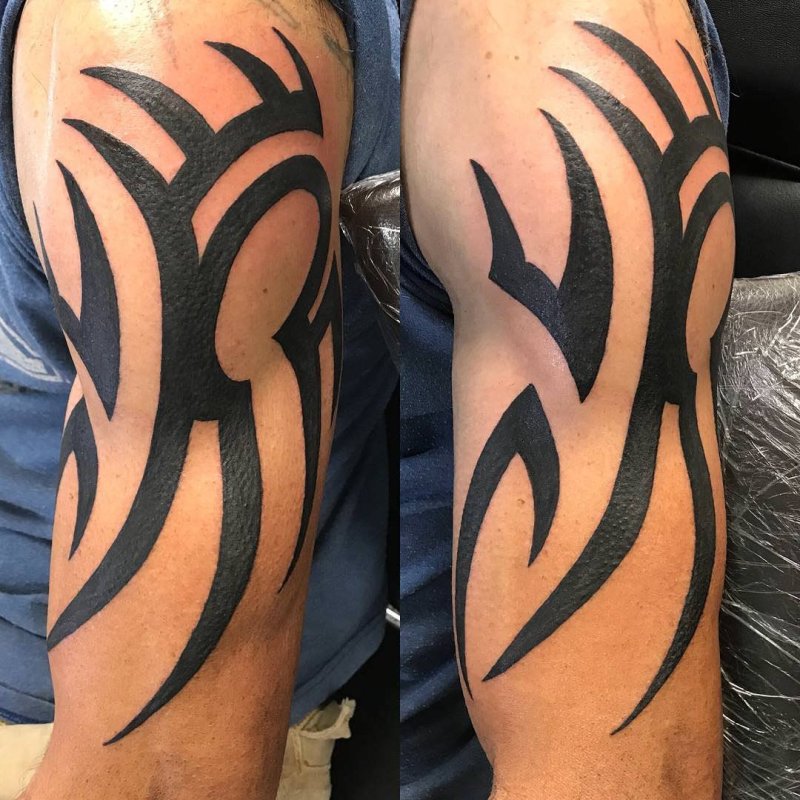 Tribal style tattoo on the shoulder for men