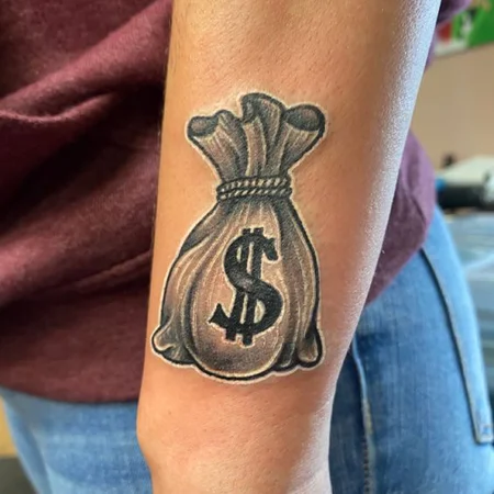 Money tattoo on forearm for women