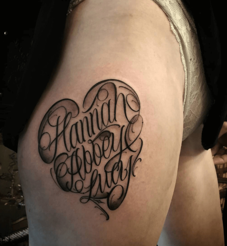 Lettering style tattoos on the thigh for women