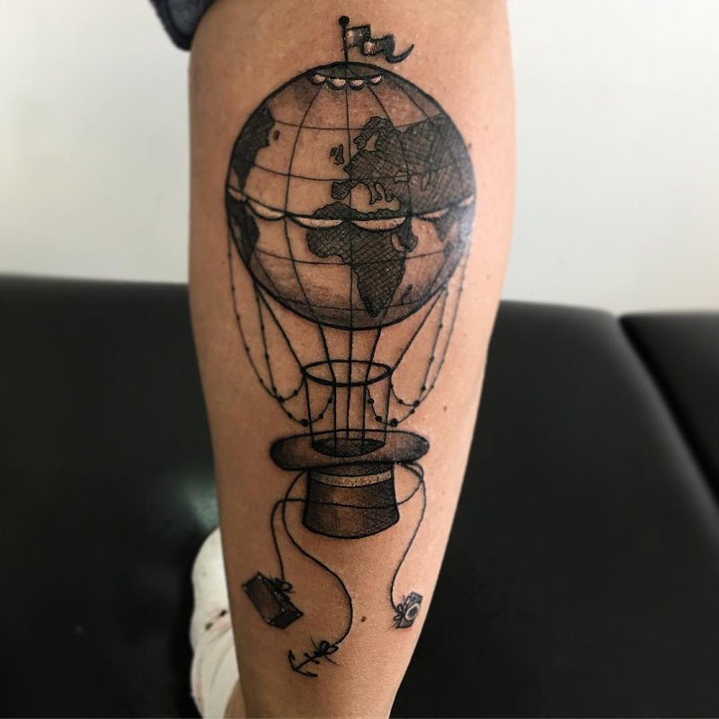 Globe tattoo on the calf for men