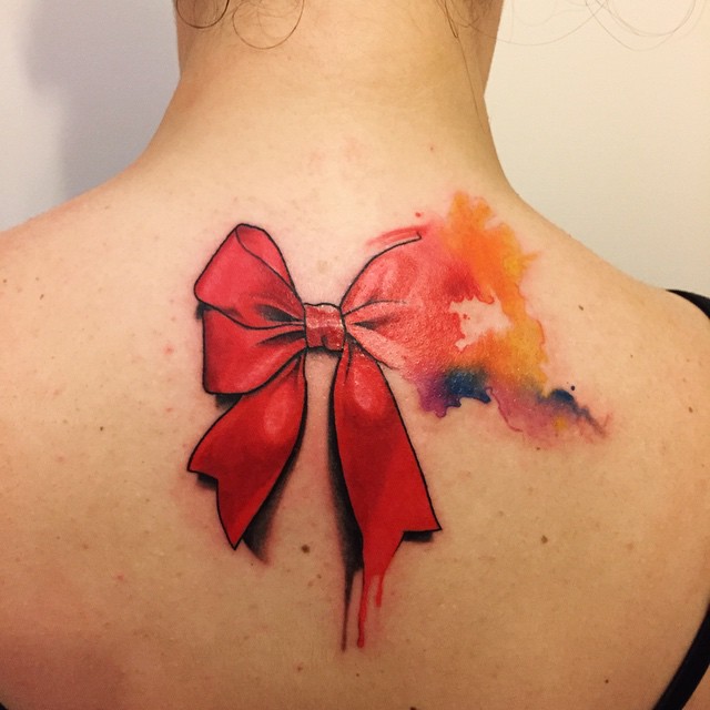 Colorful bow tattoo on back for women