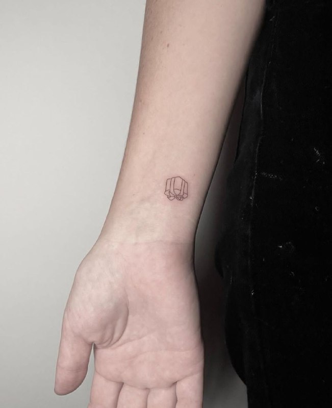 Minimalist tattoo on the wrist for women