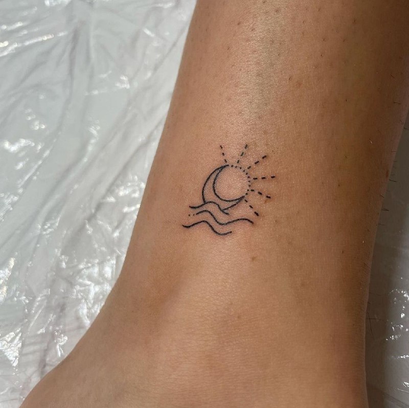 Minimalist style moon and sun tattoo on the leg for women