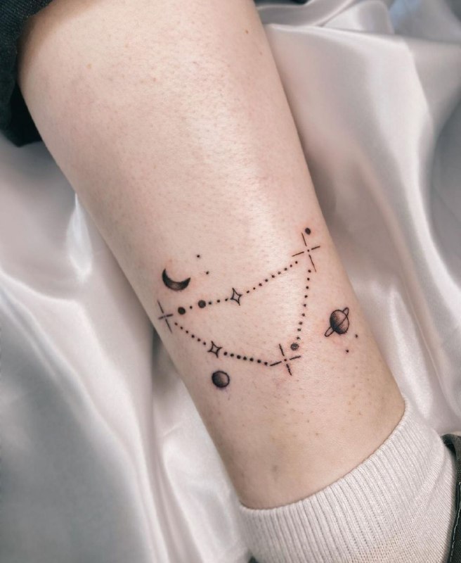 Minimalist style tattoo on the lower leg for women