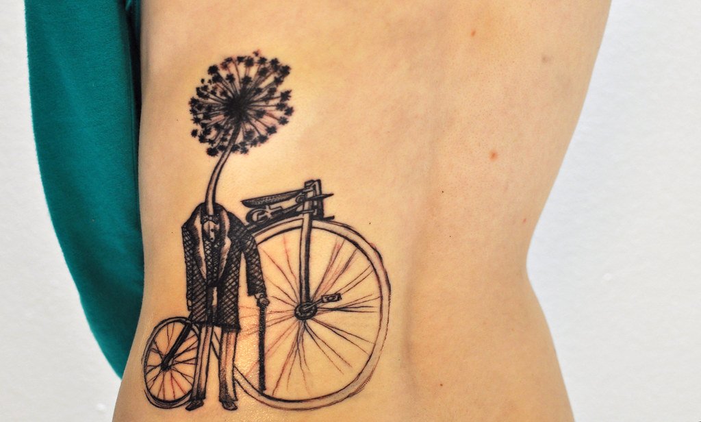 Bicycle tattoo on the side for women