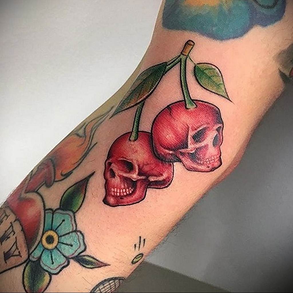 Cherry tattoo on the arm for men