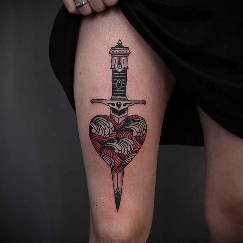 Dagger and heart tattoo on thigh for women