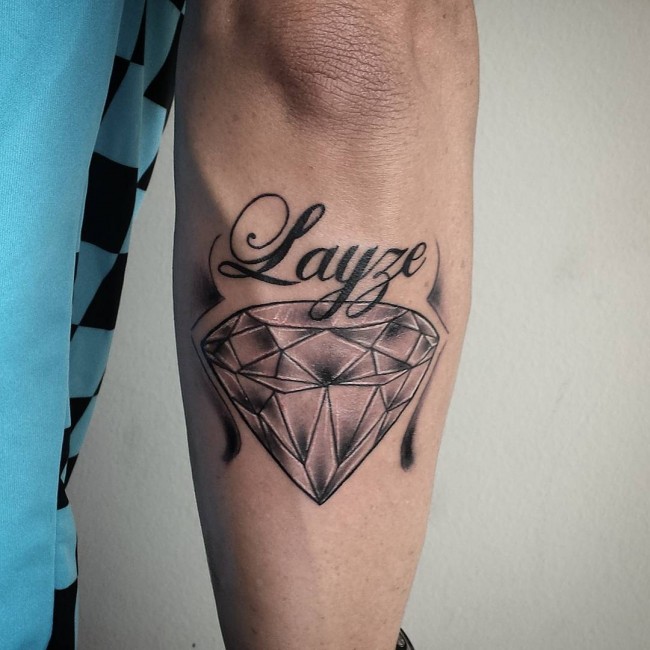 Diamond tattoo with writing on forearm for men